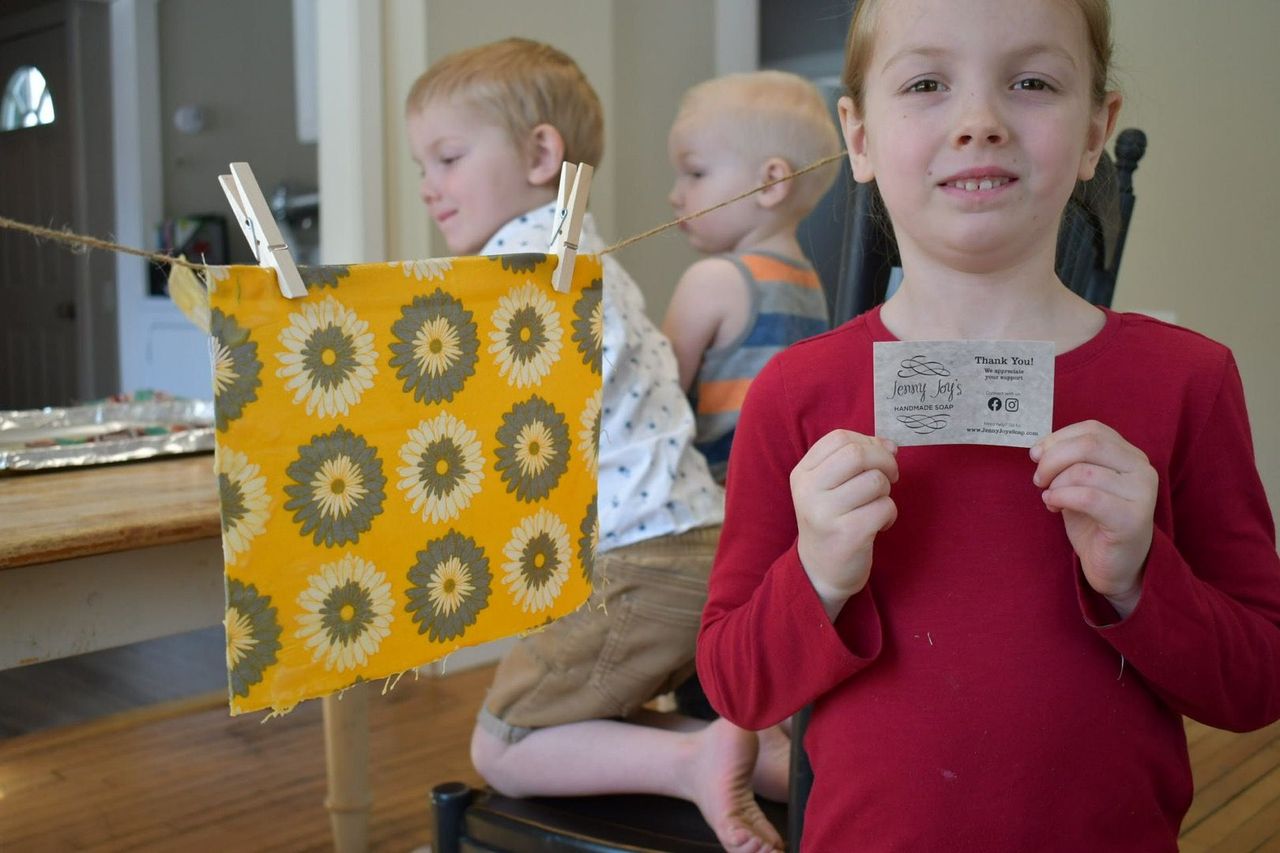 kid_smiling_with_thank_you_card_of_jenny_joys_soap